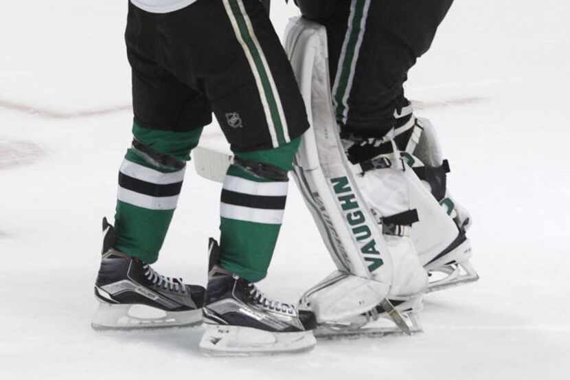 Dallas Stars goalie Antti Niemi (31) is congratulated by center Tyler Seguin (91) after the...
