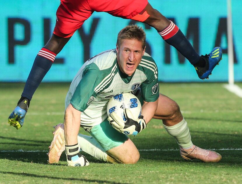 Sporting Kansas City goalkeeper Tim Melia (29) makes a save between the legs of FC Dallas...