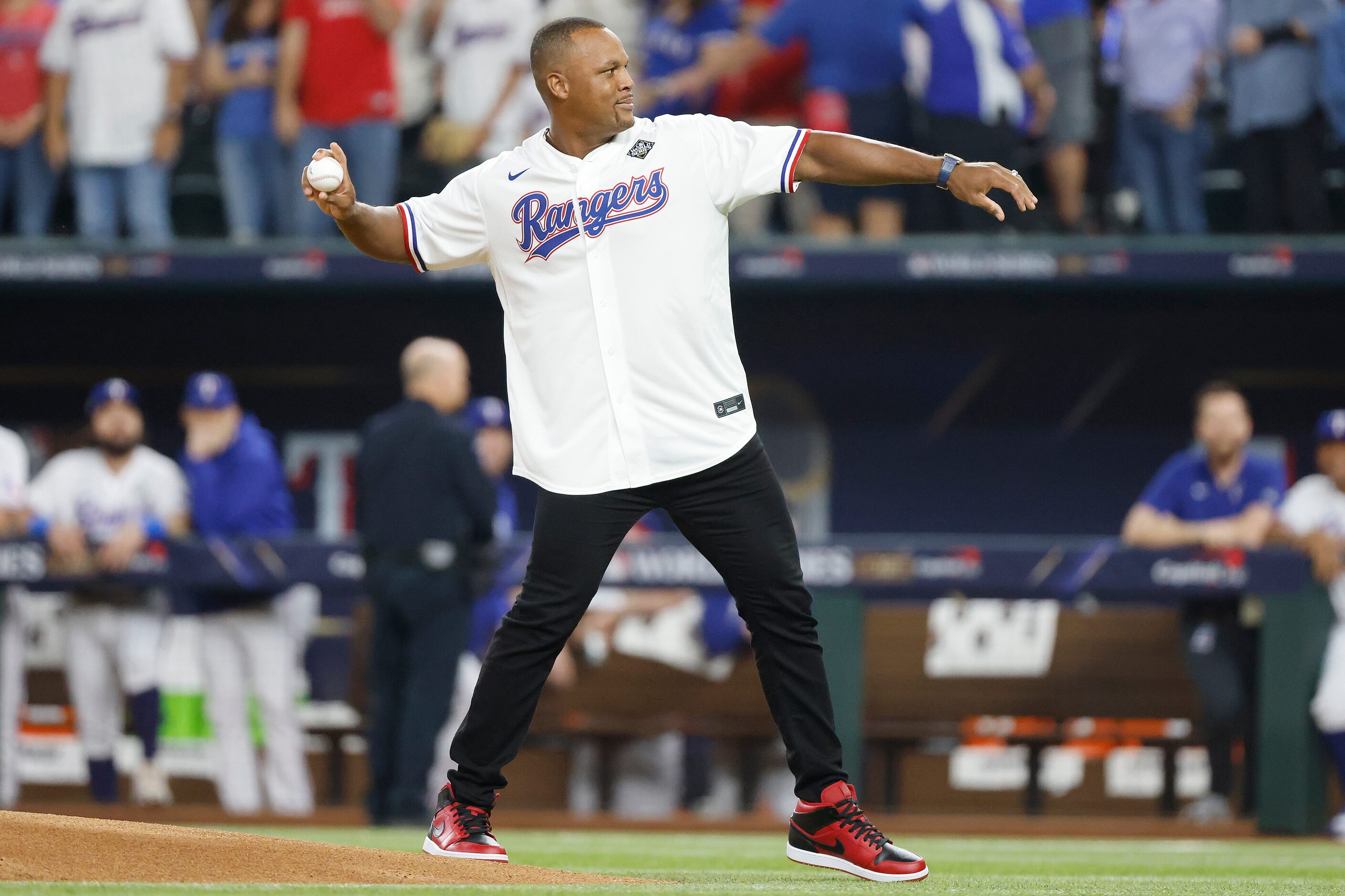 Former Texas Rangers third baseman Adrián Beltré throws the ceremonial pitch to former...