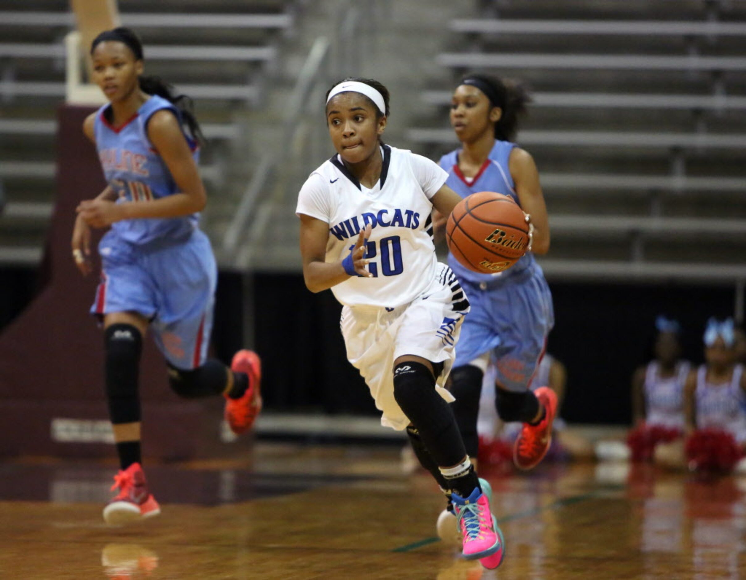 Dekaney point guard Jaelyn Richard-Harris (center) leads her offense during the second half...