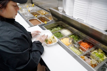 Carla Esparza makes street tacos at the new Fuel City in Cedar Hill.