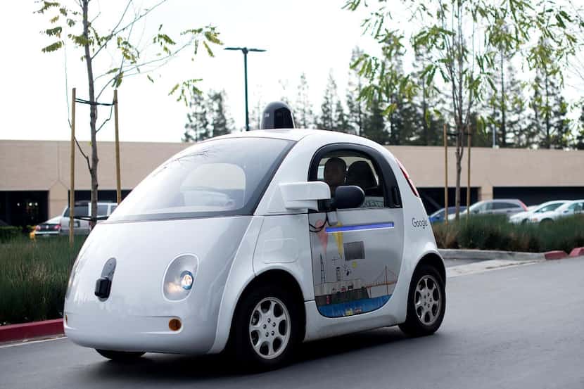 
A self-driving car traverses a parking lot at Google's headquarters in Mountain View,...