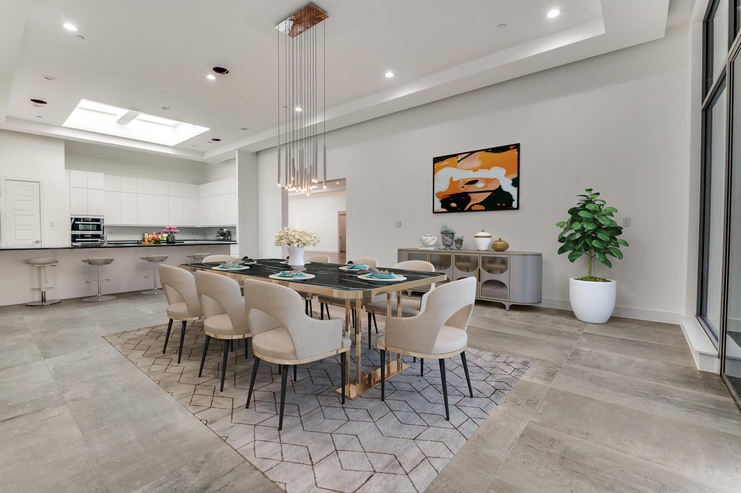 The kitchen, which features Miele appliances, looks into the spacious dining room.