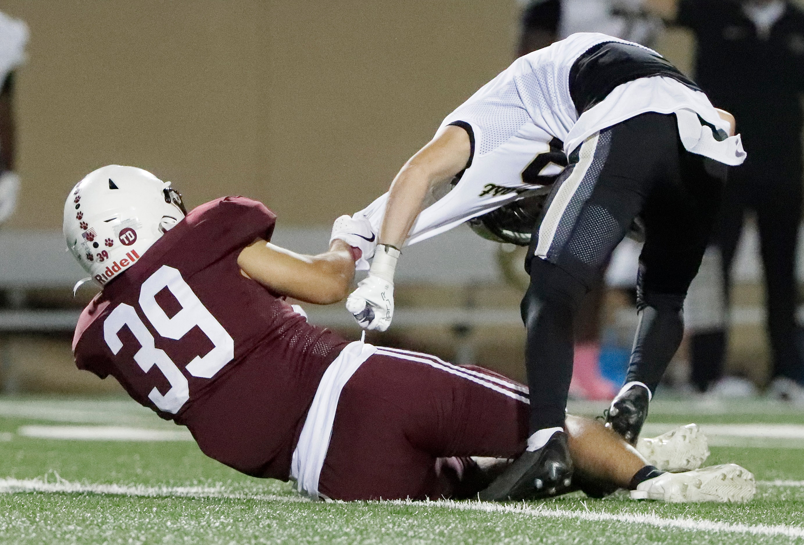 Plano High School defender Hugo Rodriguez (39) pulls down Plano East High School kick...