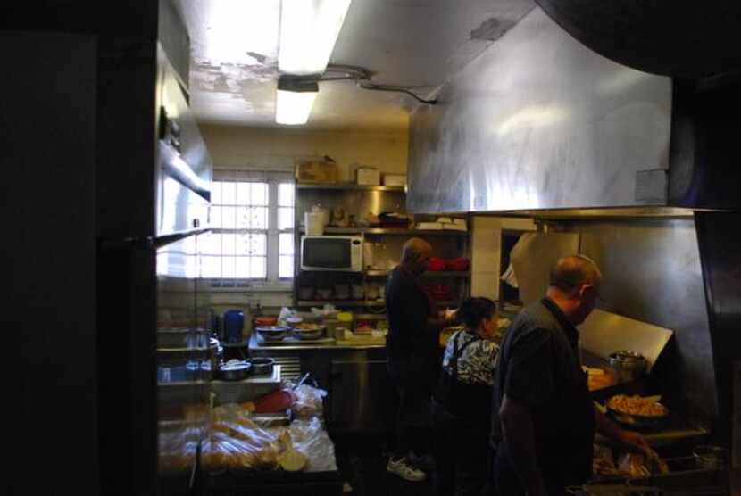 
The kitchen at Club Schmitz sits behind the bar, where co-owner Bob Schmitz (right) said...