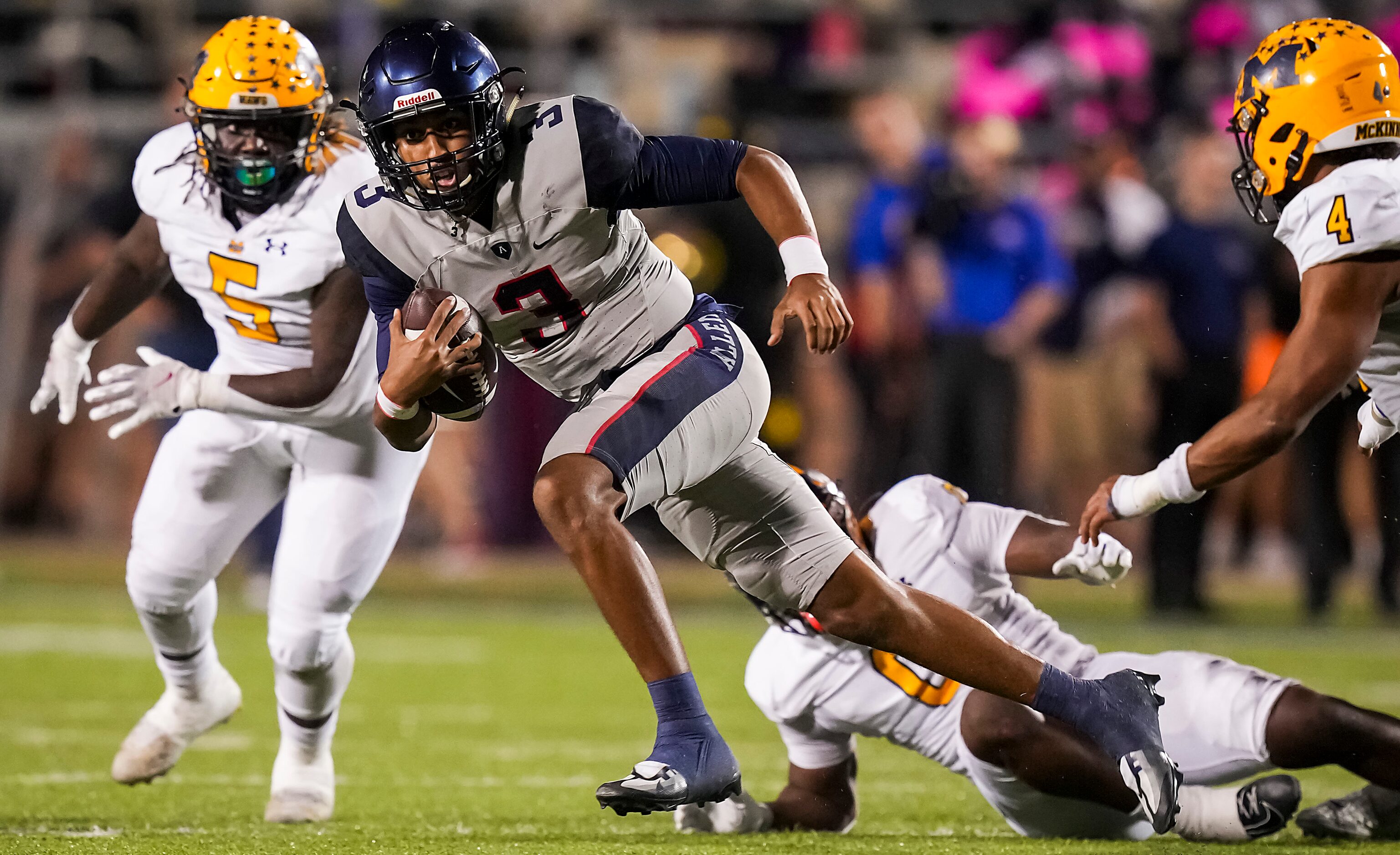 Allen quarterback Mike Hawkins (3) scrambles away from McKinney defenders D'Kedrion Abrams...