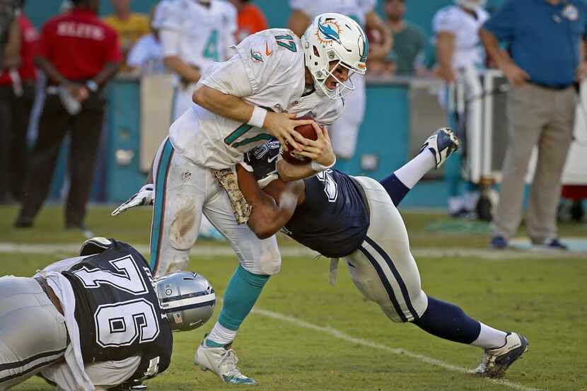 Miami Dolphins quarterback Ryan Tannehill (17) is sacked by Dallas Cowboys defensive end...