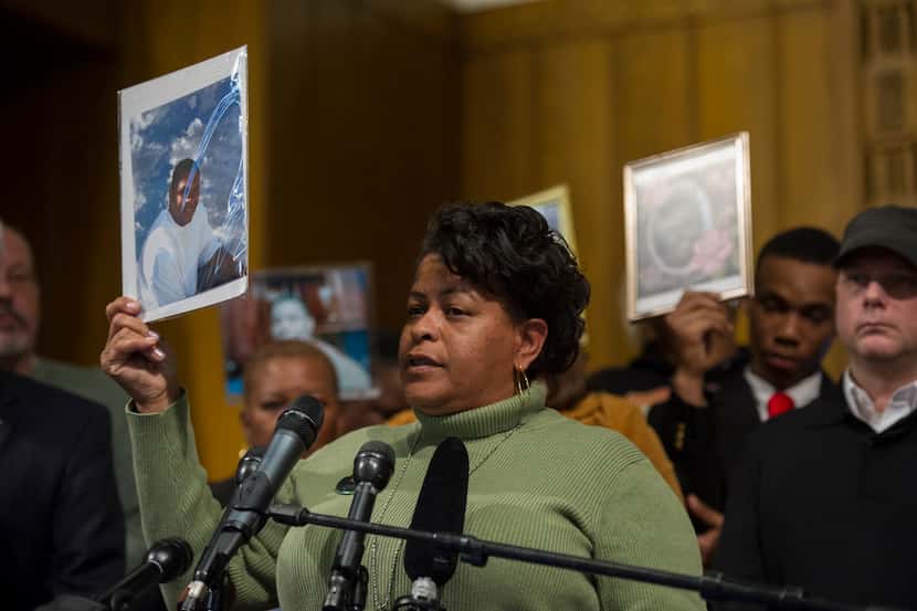 Davoria Williams of Oakland, Calif., holds a photo of her son, Clifford D. Snead, who was...