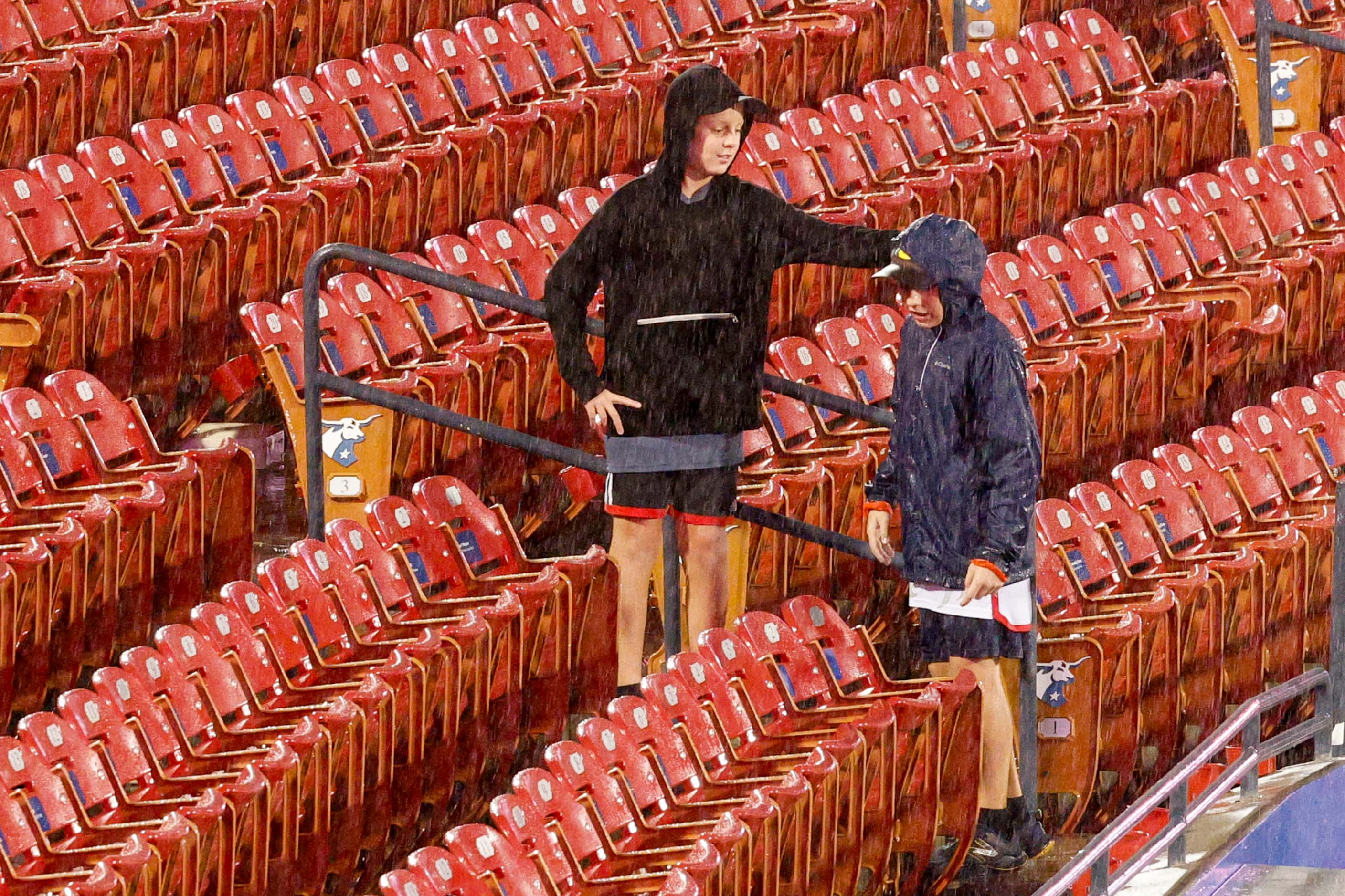 Kids play in the rain during a lightning delay before an MLS game between FC Dallas and the...