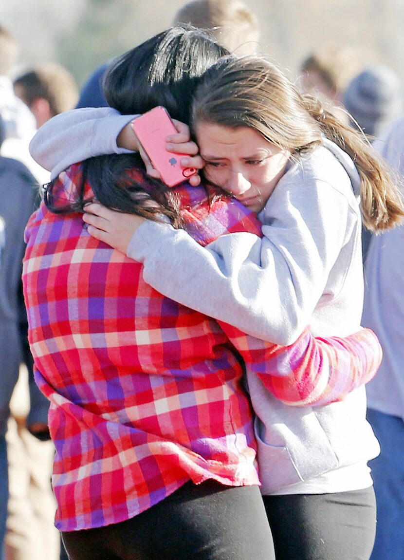 Students comforted one another outside of Arapahoe High School after a shooting on the...