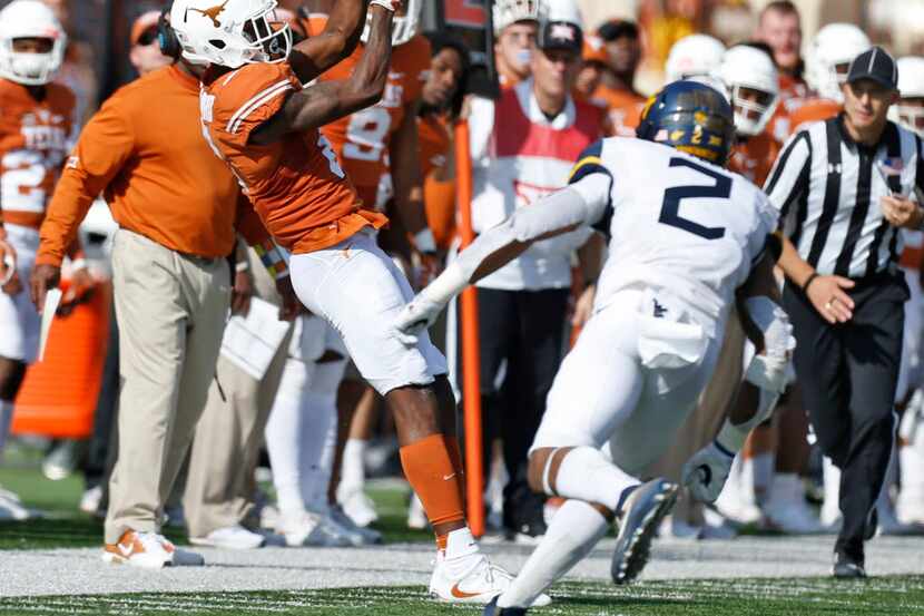 Texas Longhorns wide receiver Dorian Leonard (8) catches a pass in front of West Virginia...
