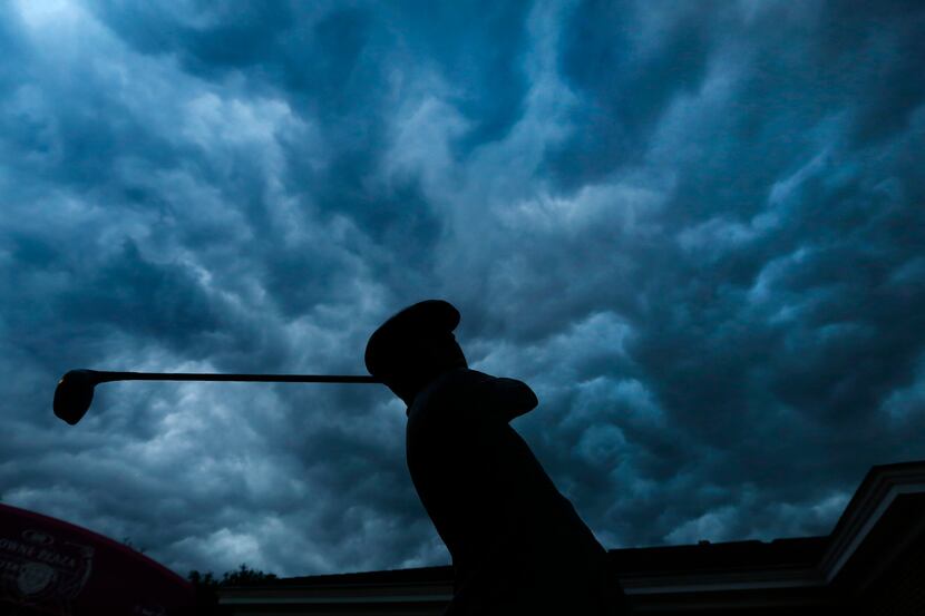Storm clouds roll over the statue of famed golfer Ben Hogan after play was halted at the...