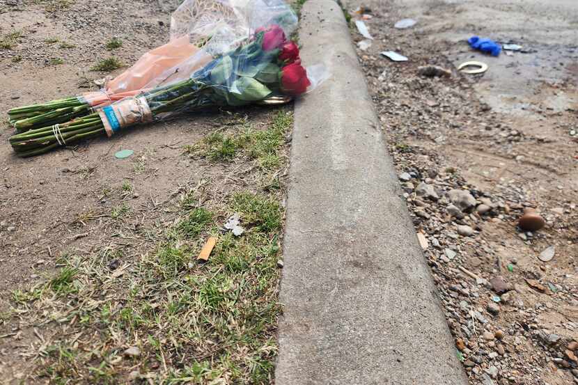 Two small bundles of flowers sat on the ground in the 4500 block of Collins Avenue in South...