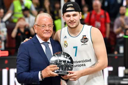 Real Madrid's Slovenian Luka Doncic poses for a photograph with the team's President...