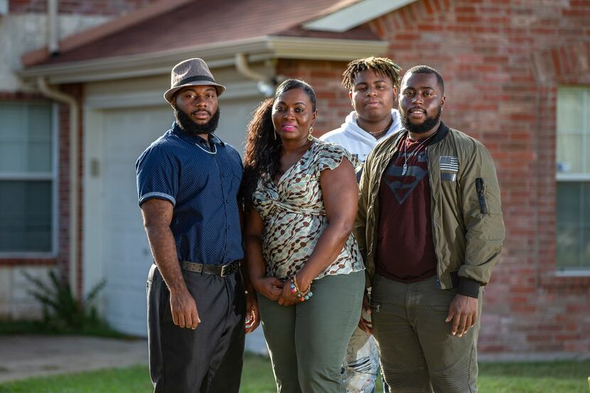 Sammie Anderson with her sons Samuel Bible, 18, left, Ty Anderson, 15, third from left, and...
