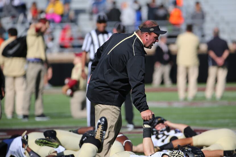 FILE - Mike Elko encourages Wake Forest players during warmups before a game against Boston...