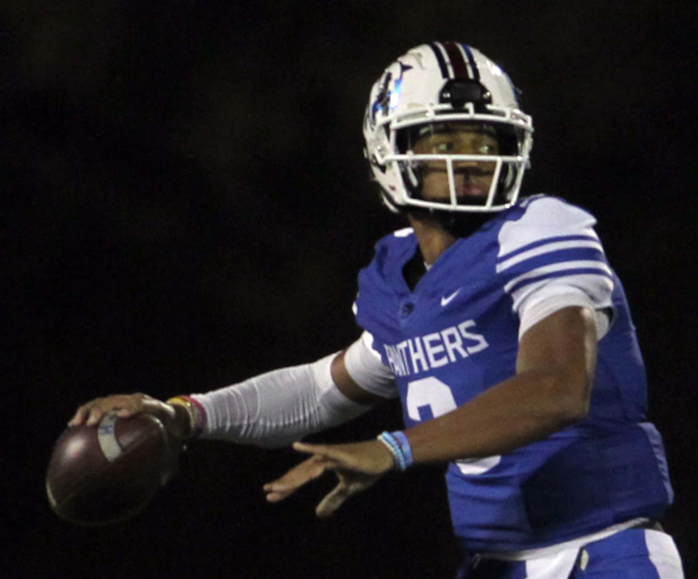 Duncanville quarterback Grayson James (3) looks to launch a pass downfield during the first...