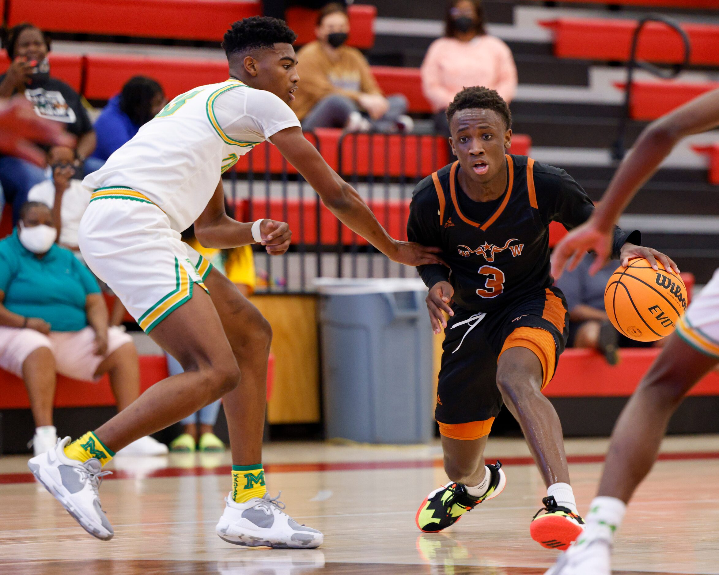 W.T. White guard Charles Fofanah (3) dribbles around Madison forward Quintin Spencer (13)...