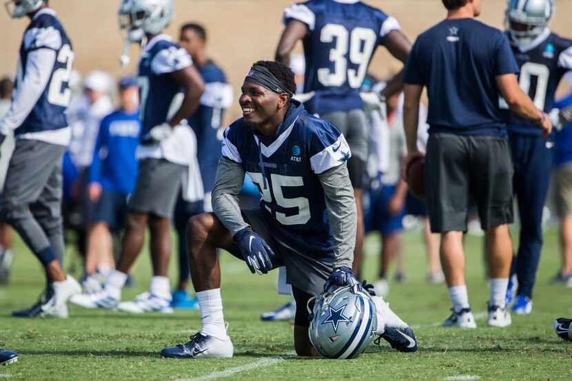 Dallas Cowboys free safety Xavier Woods (25) smiles an takes a knee during an afternoon...