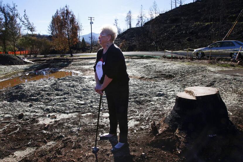 
Darlene Simmons looks over the lot where her home of 45 years stood. It burned to the...