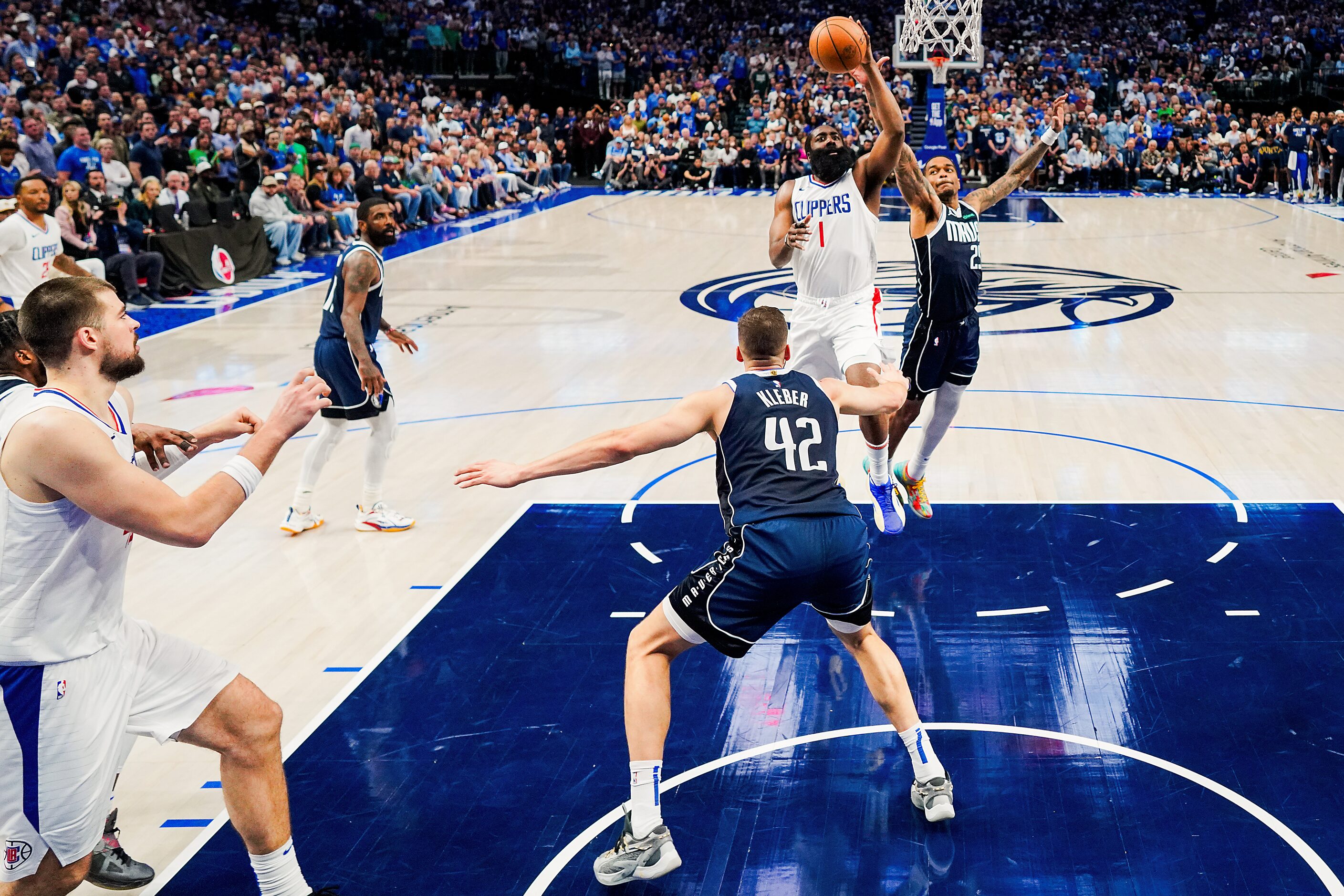 LA Clippers guard James Harden (1) scores on a floater over Dallas Mavericks forward Maxi...