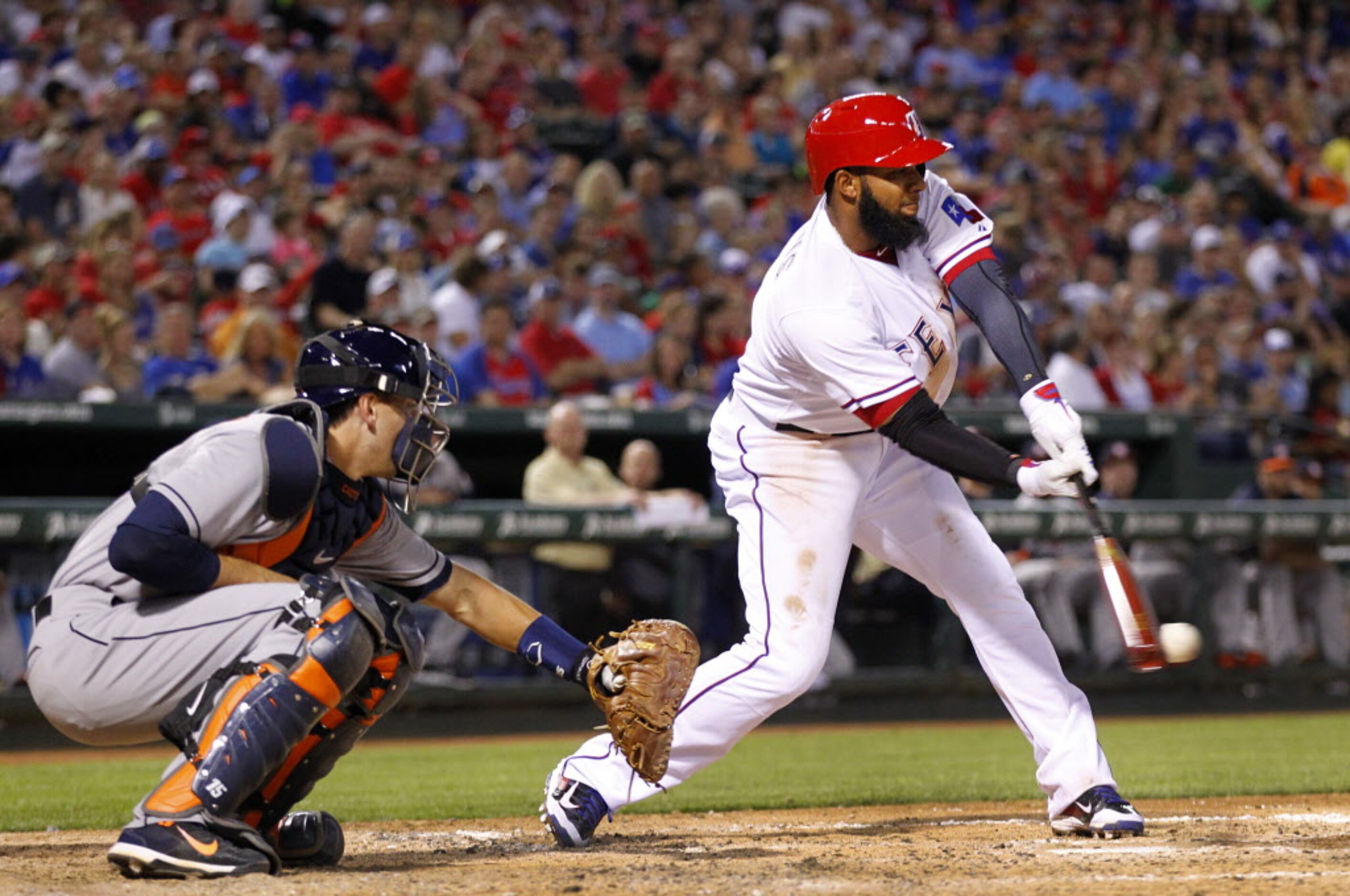 Texas Rangers shortstop Elvis Andrus hits the ball in the fourth inning against the Houston...