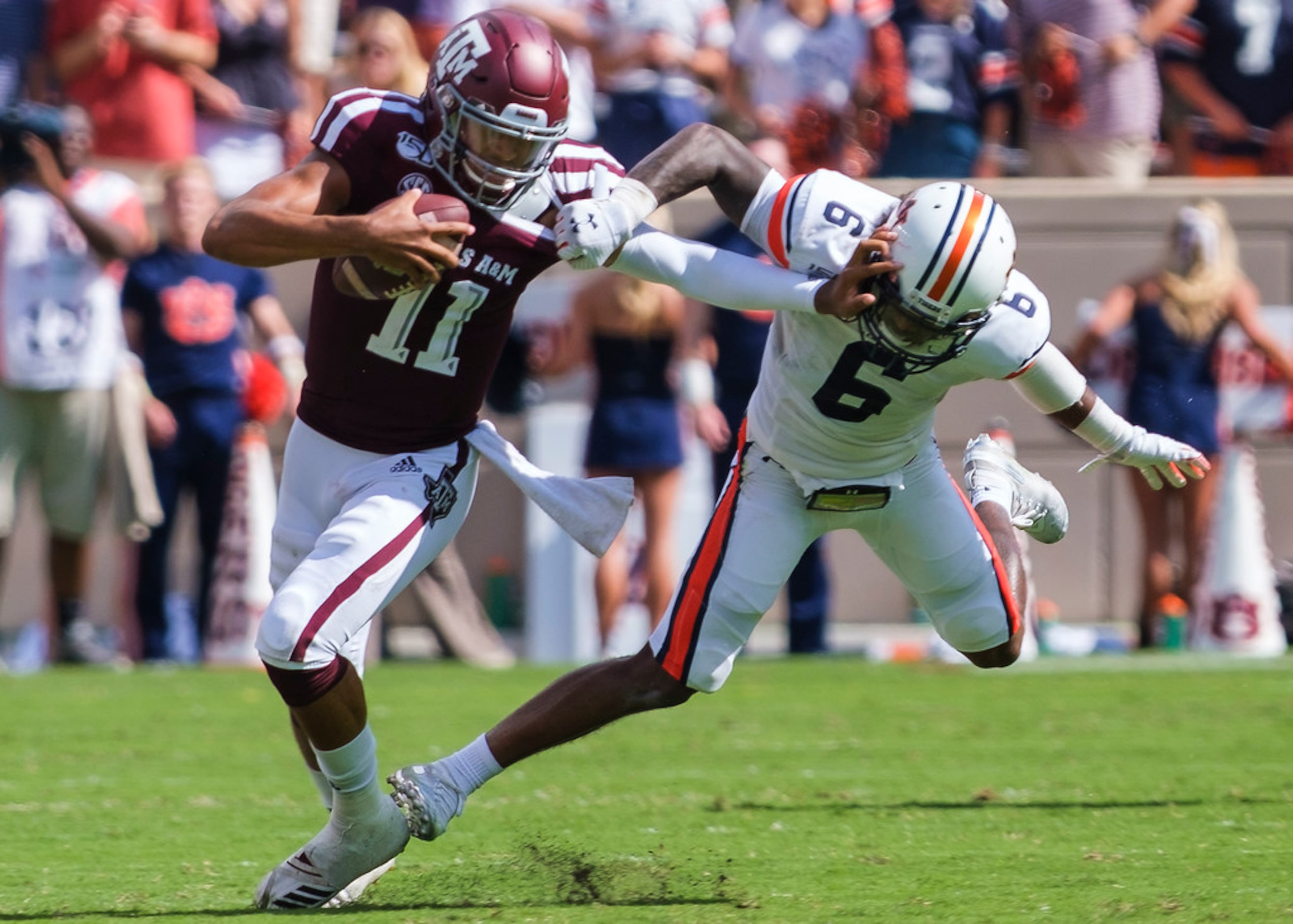 Texas A&M quarterback Kellen Mond (11) tries to fight off Auburn defensive back Christian...