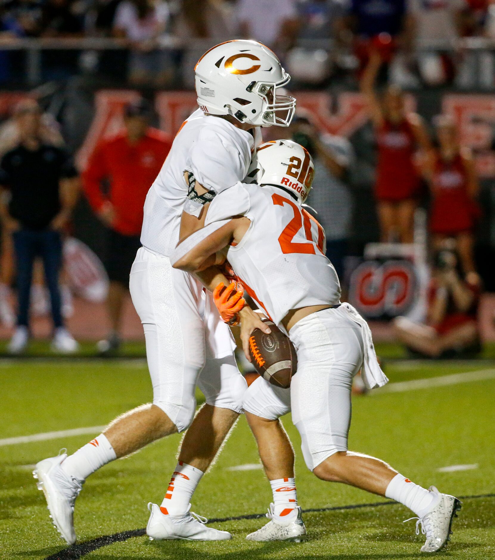 Celina quarterback Noah Bentley (1) collides in the backfield with running back Sean Rabe...