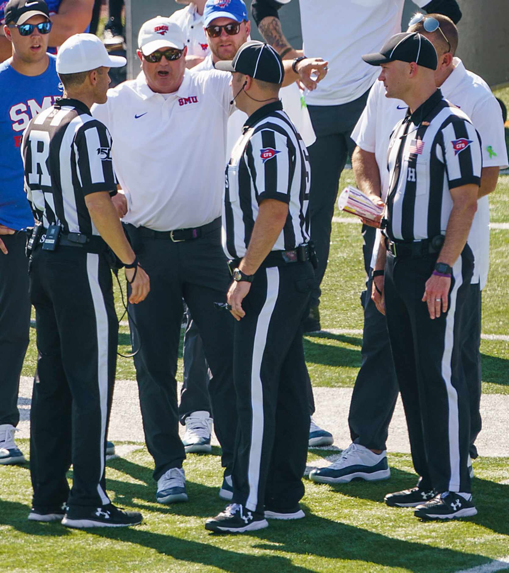 SMU head coach Sonny Dykes talks with officials during the first half of an NCAA football...