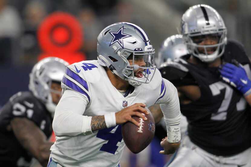 Dallas Cowboys quarterback Dak Prescott (4) scrambles to avoid pressure from the Las Vegas...