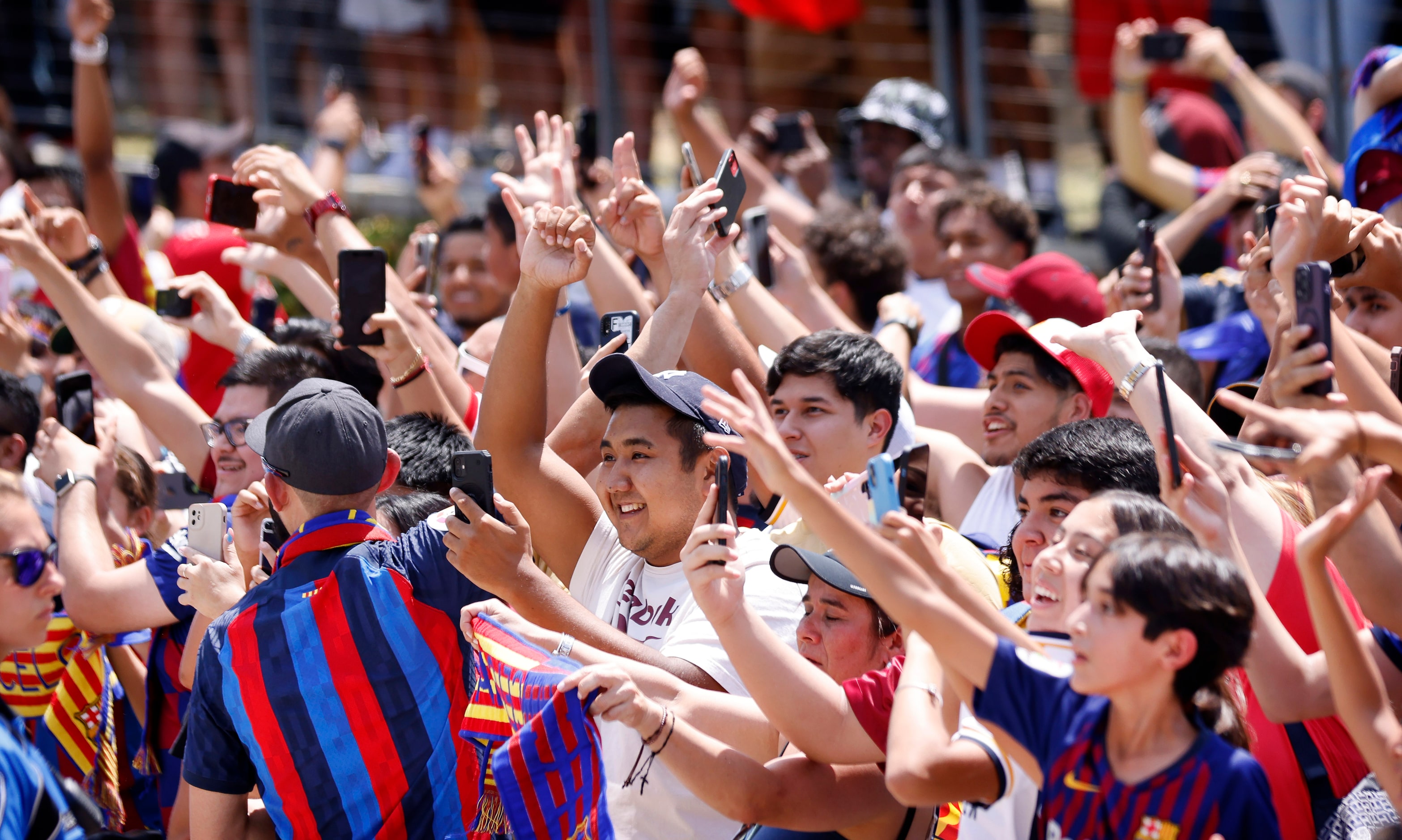 Real Madrid and Barcelona soccer fans cheer as the team buses arrive for their Soccer...