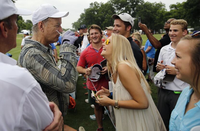 Actor Bill Murray takes a sip of Lindsey Feldman's drink in between holes during the...