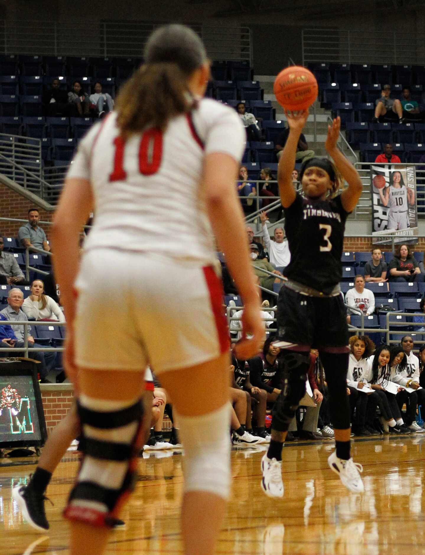 Mansfield Timberview point guard Desiree Wooten (3) sinks a 3-pointer at the buzzer ending...