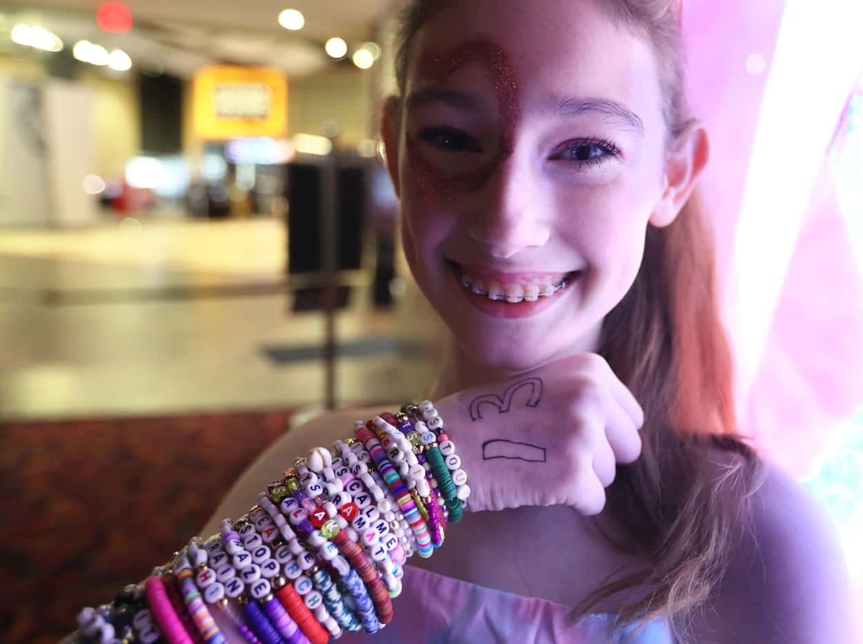 Molleigh McDonald, 13, shows off her friendship bracelets before Taylor Swift's movie at...
