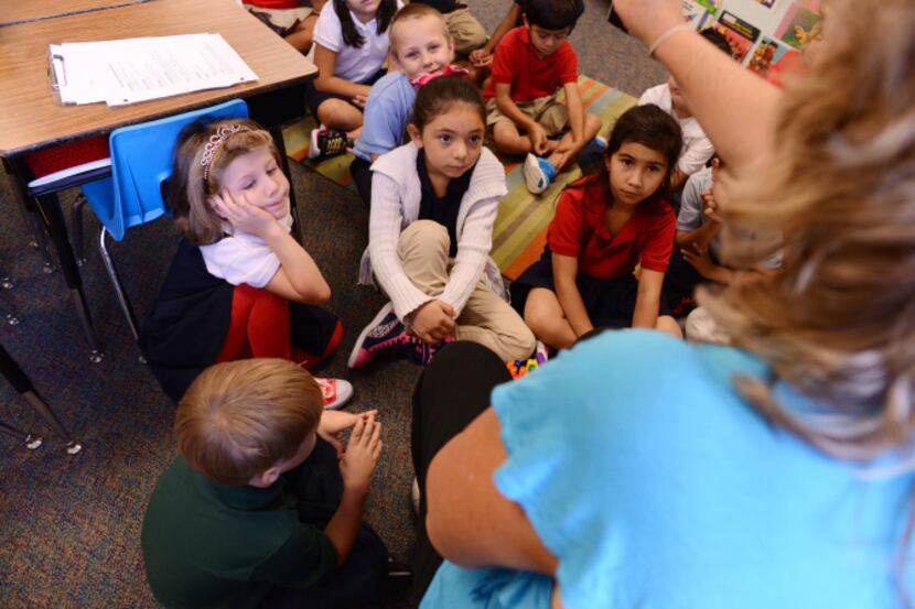Dual-language teacher Gina Fernandez talks in Spanish to her students during a lesson at...