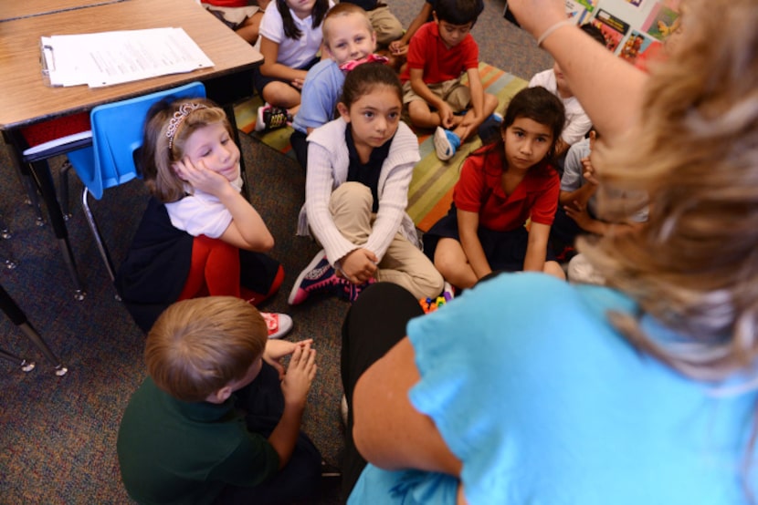 Dual-language teacher Gina Fernandez talks in Spanish to her students during a lesson at...