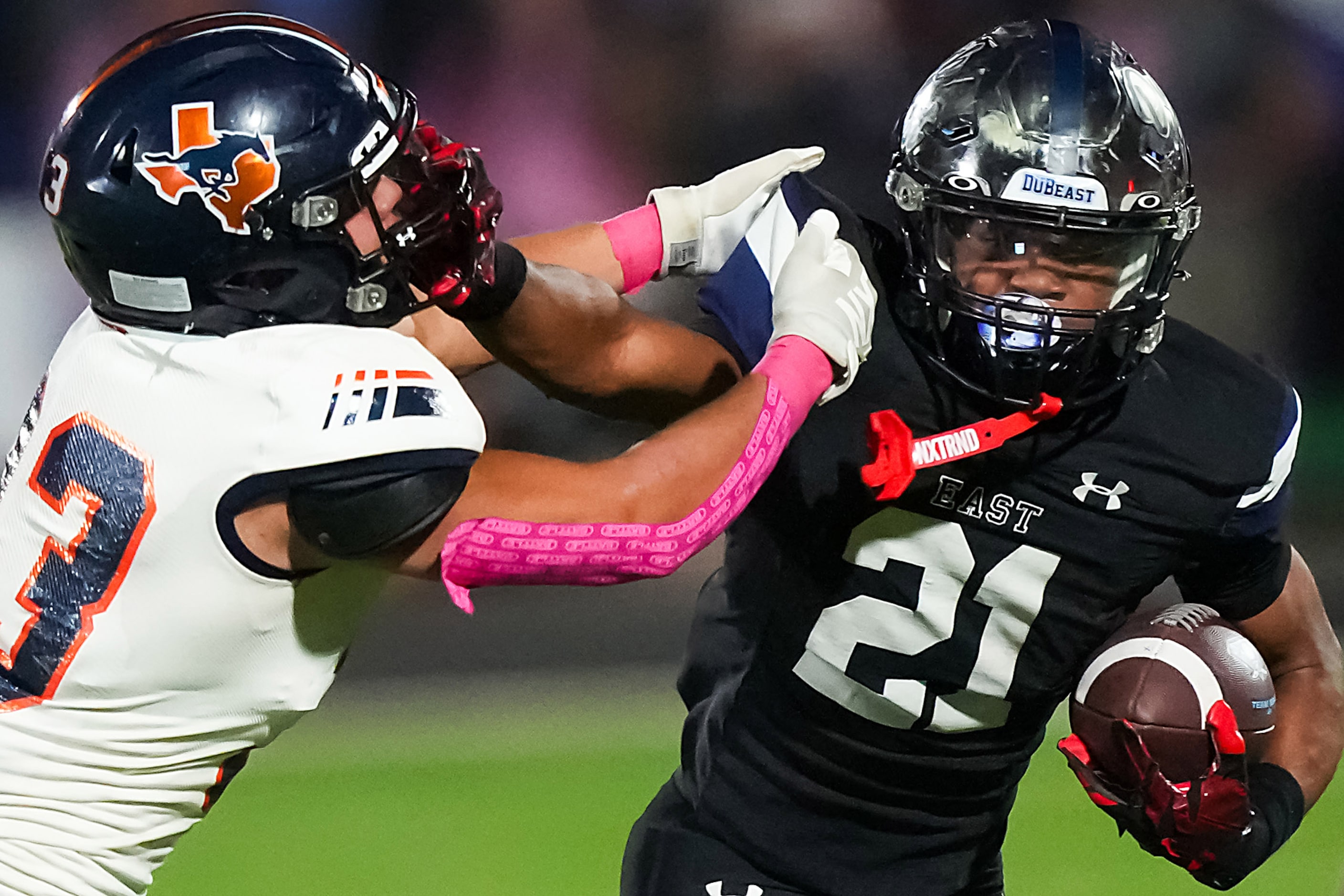 Wylie East running back  Michael Henderson III (21) pushes away from Sachse linebacker...