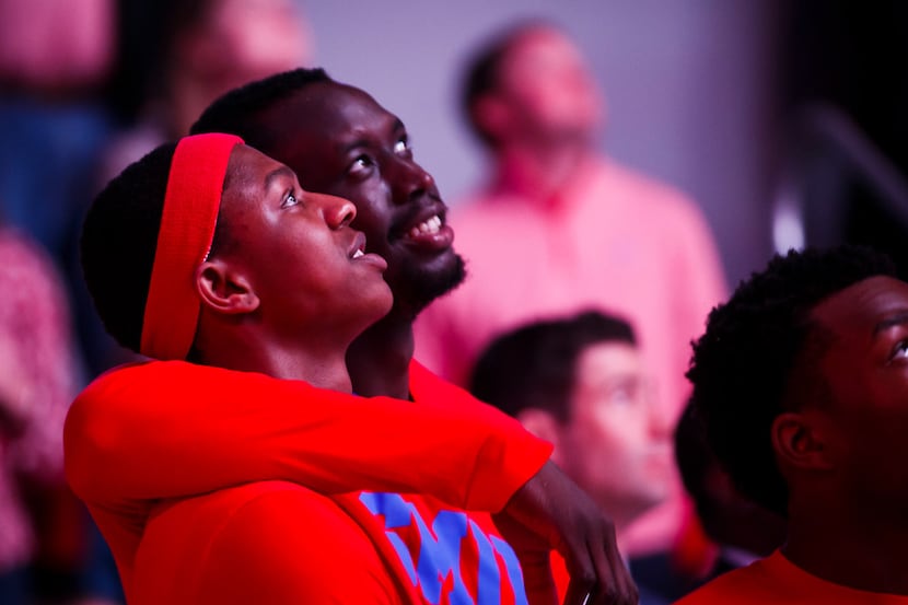 SMU guard William Douglas (3) watches a pregame video with forward Akoy Agau (23) before an...