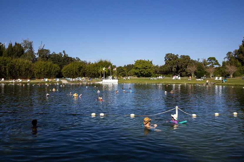 Swimmers wade in the mineral-rich waters of Warm Mineral Springs in North Port, Fla.