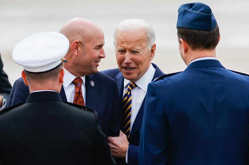 President Joe Biden chat with Rep. Jake Ellzey, R-Midlothian, a former Navy fighter pilot,...