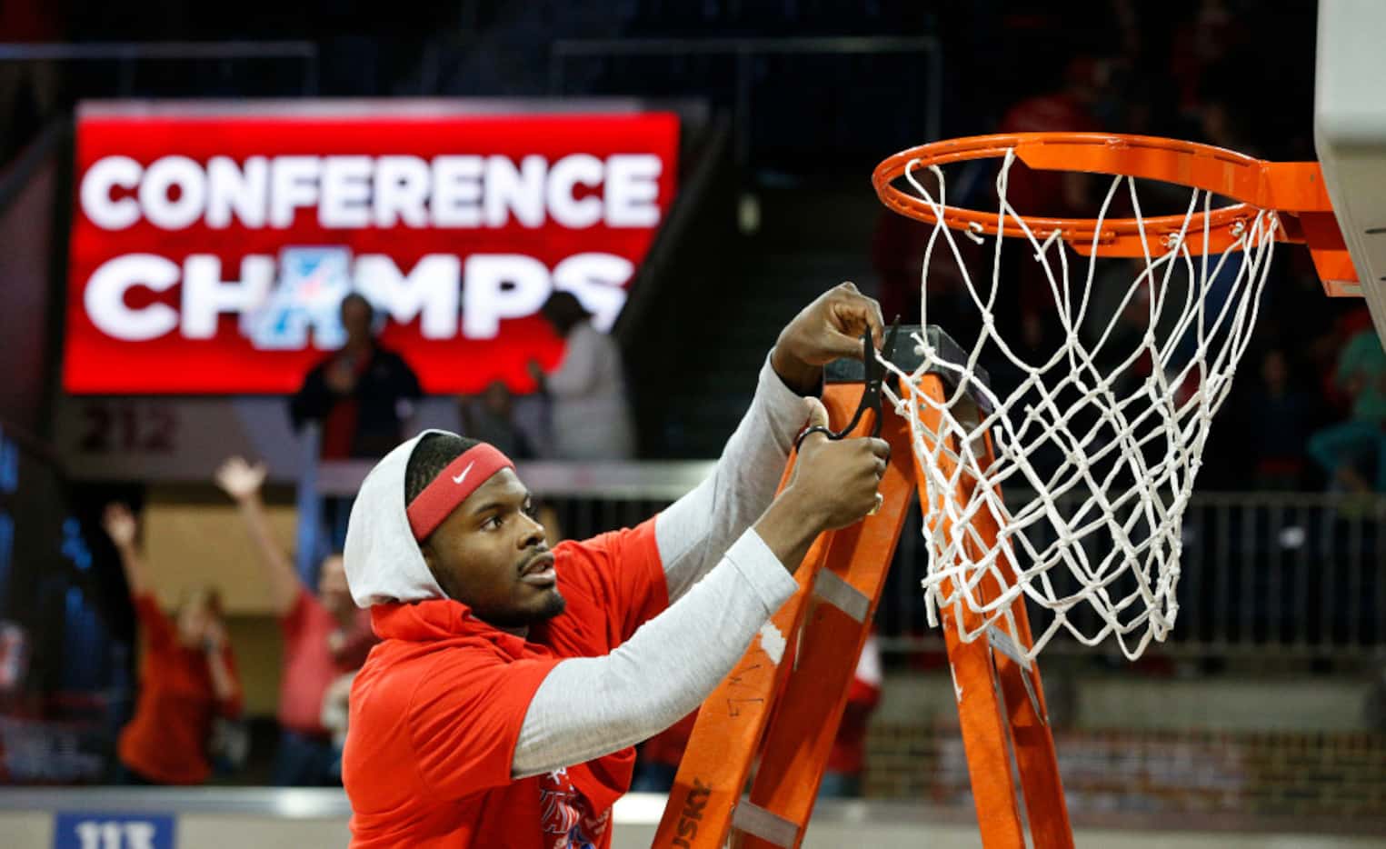 Southern Methodist Mustangs guard Ben Emelogu II (21) cuts the net after his team won the...