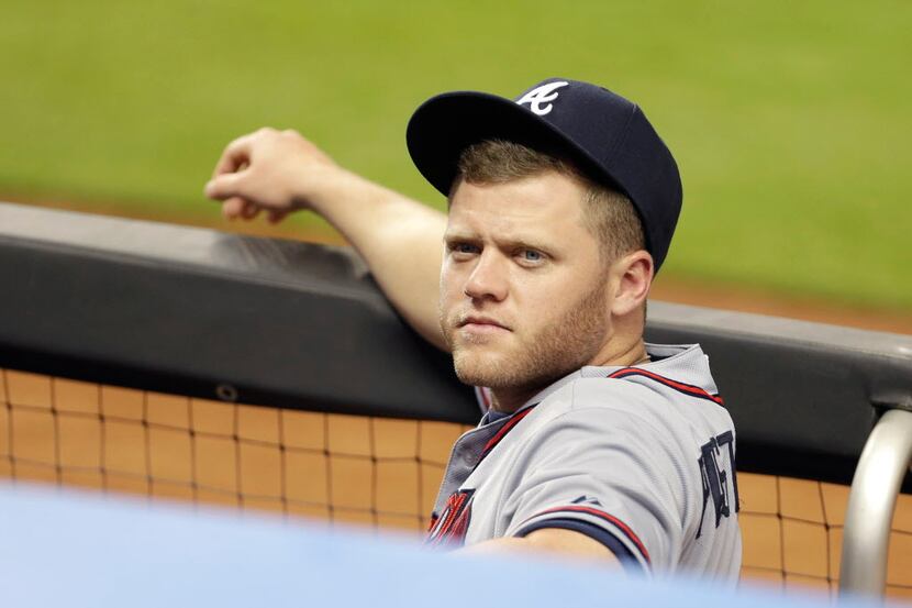 Atlanta Braves second baseman Tyler Pastornicky watches from the dugout during a baseball...