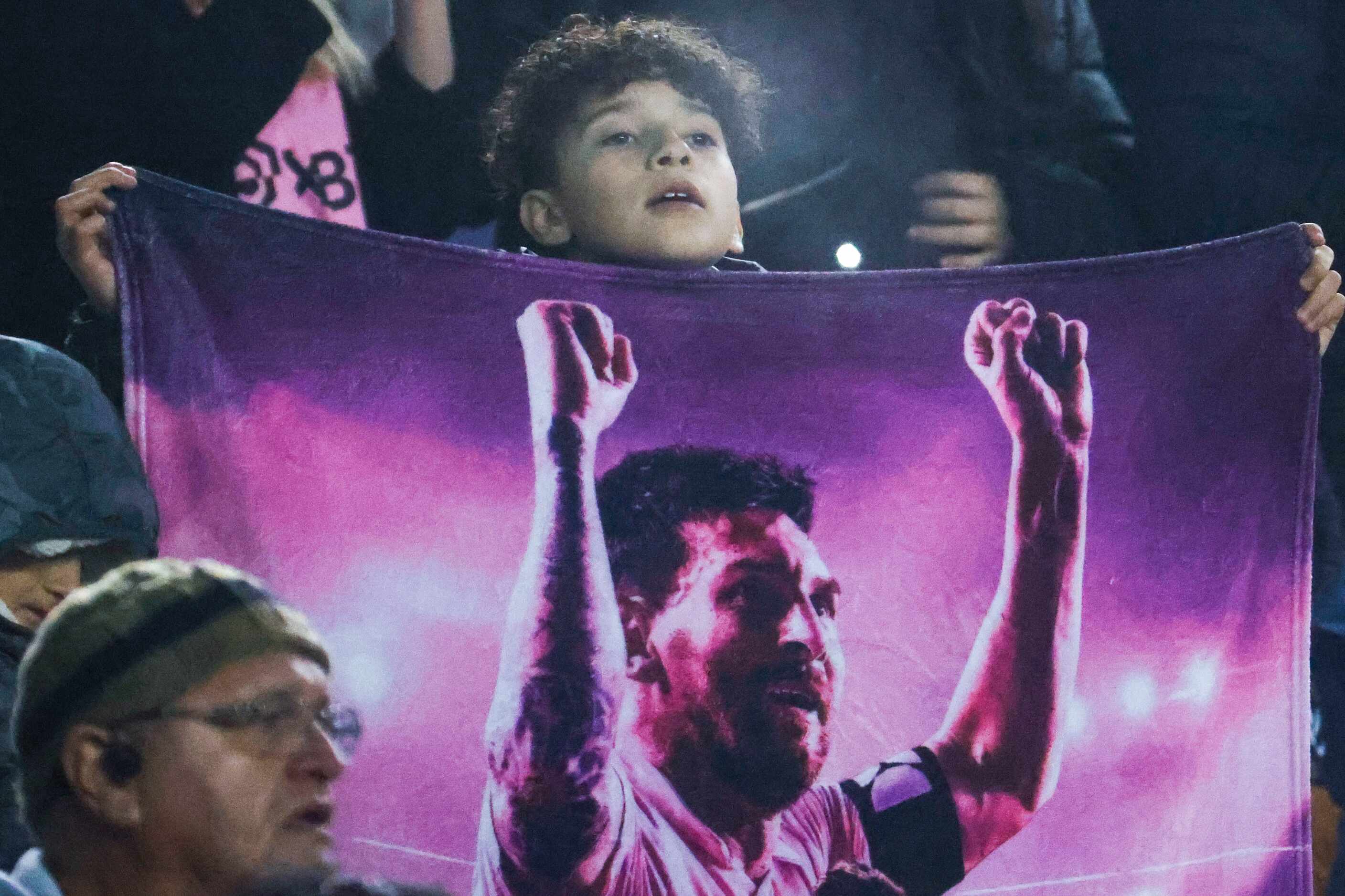 A young fan holds a sign of Inter Miami forward Lionel Messi during the second half of a...