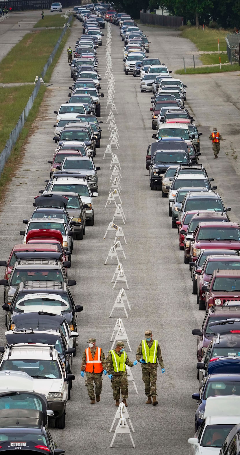 Cars lined up for a North Texas Food Bank free food distribution at Fair Park on May 14.