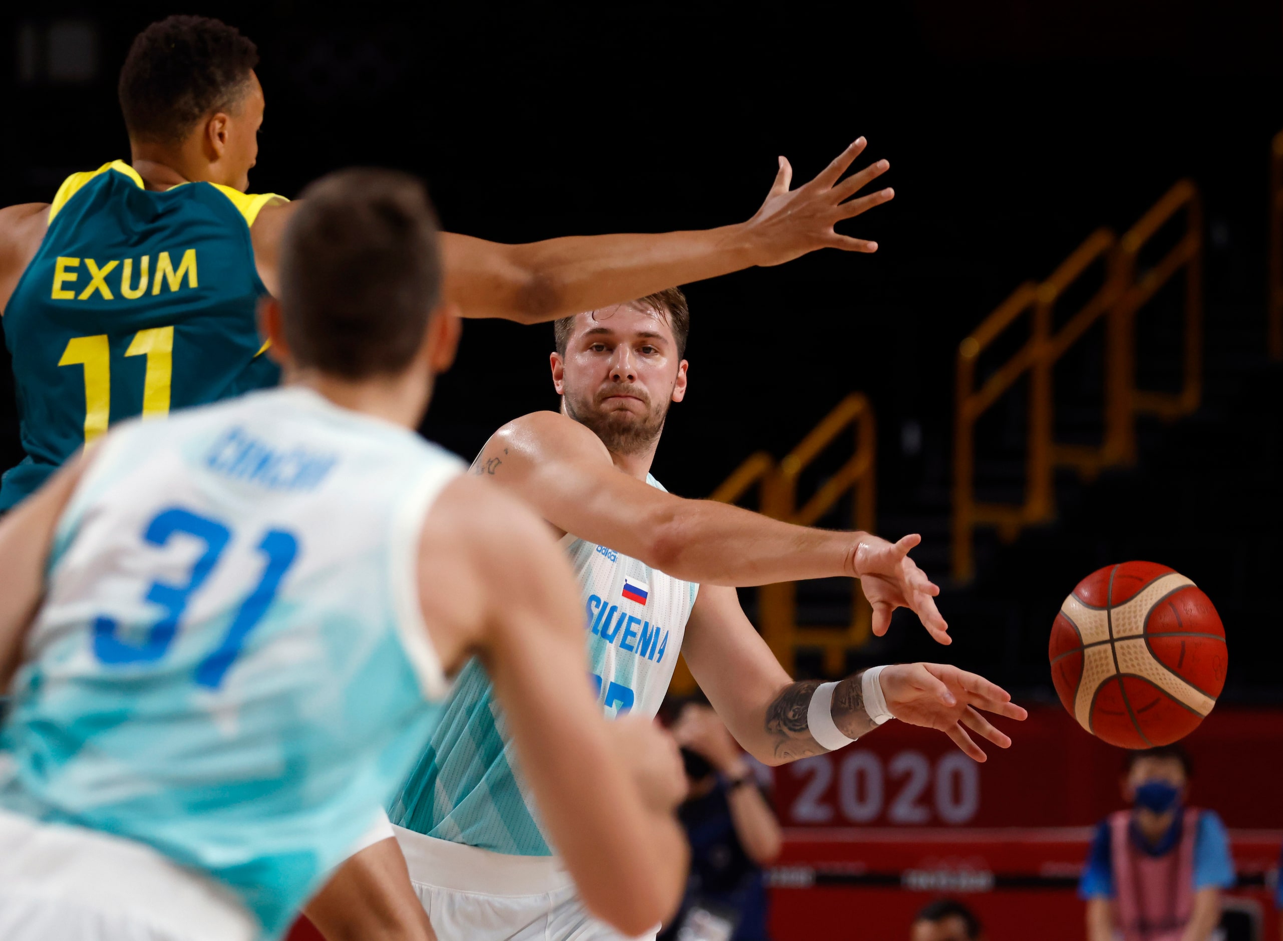 Slovenia’s Luka Doncic (77) passes to Slovenia’s Vlatko Cancar (31) as Australia’s Dante...