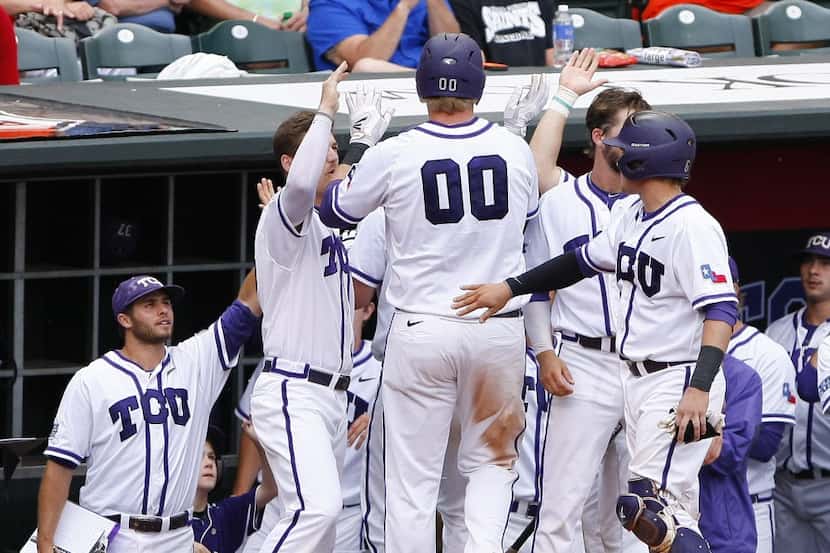 TCU's Kevin Cron (00) celebrates with his team after scoring a run in the third inning of...
