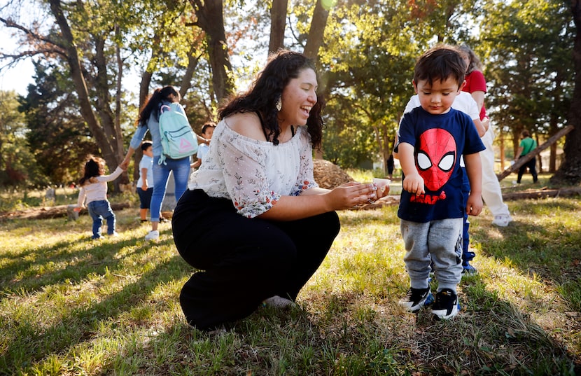 North Texas Master Naturalist Nancy Escobar helps Israel Tapia plant milkweed seeds in W.W....