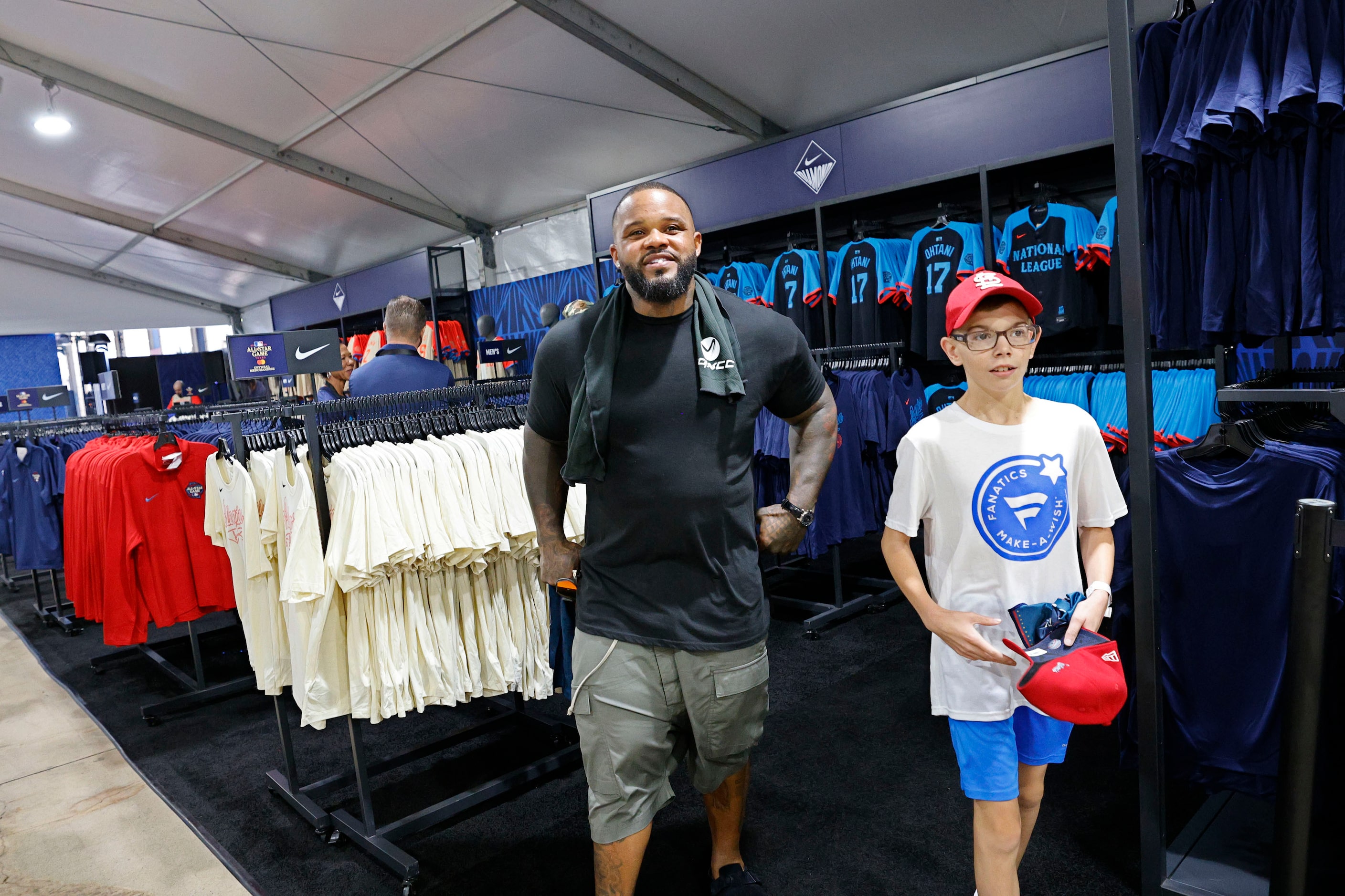 Make-a-Wish kid Steven Long, 11, of Troy Ill. walks with former Texas Rangers slugger Prince...