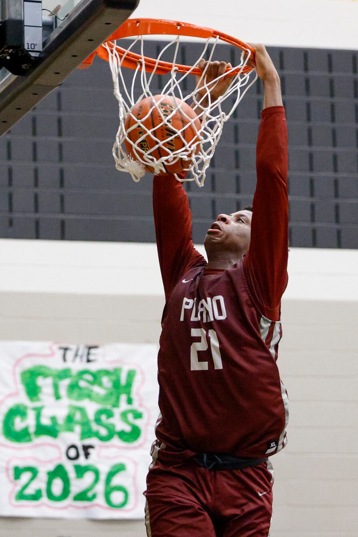 Plano forward Justin McBride dunks the ball during the second half of a non-district game...