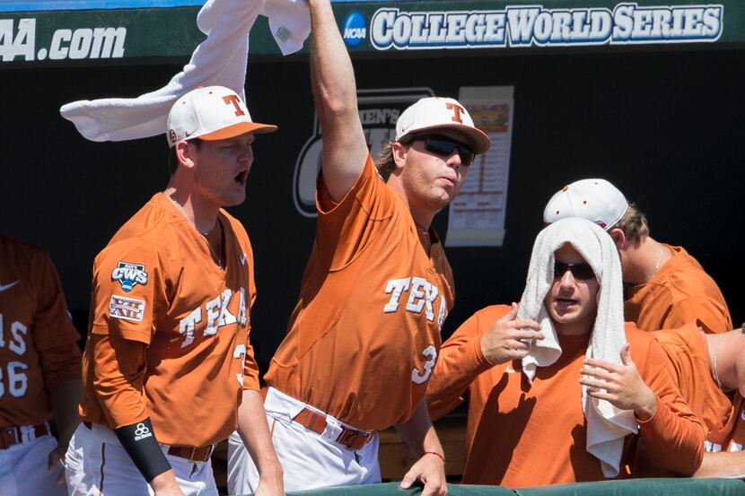 Players in the Texas dugout celebrate after Ben Johnson scored against Vanderbilt in the...